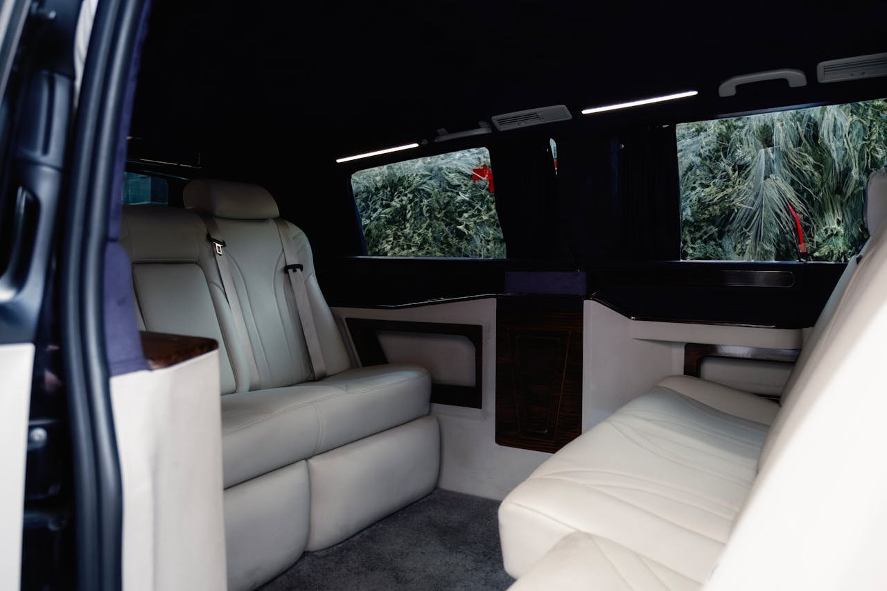Spacious and comfortable leather seating inside a modern luxury van, perfect for travel.
